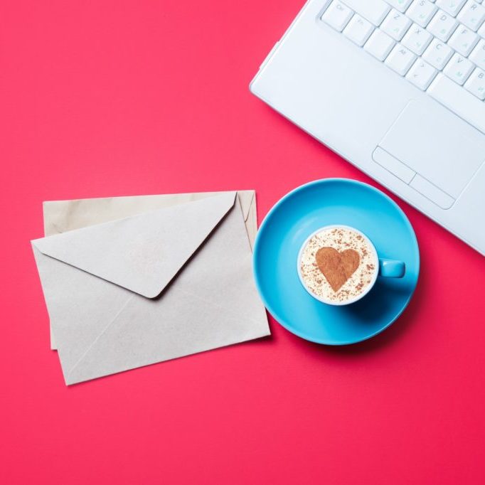 cup. envelopes and laptop